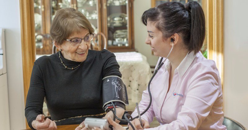 Compassion Senior Care - 24 hour care- homecare assistant taking blood pressure