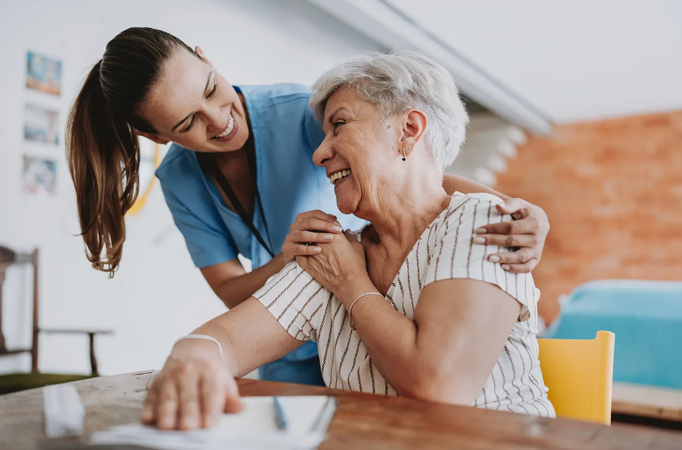 Senior smiling and enjoying spending time with her caregiver in Calgary