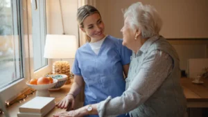 Caregiver looking and smiling at senior Lady